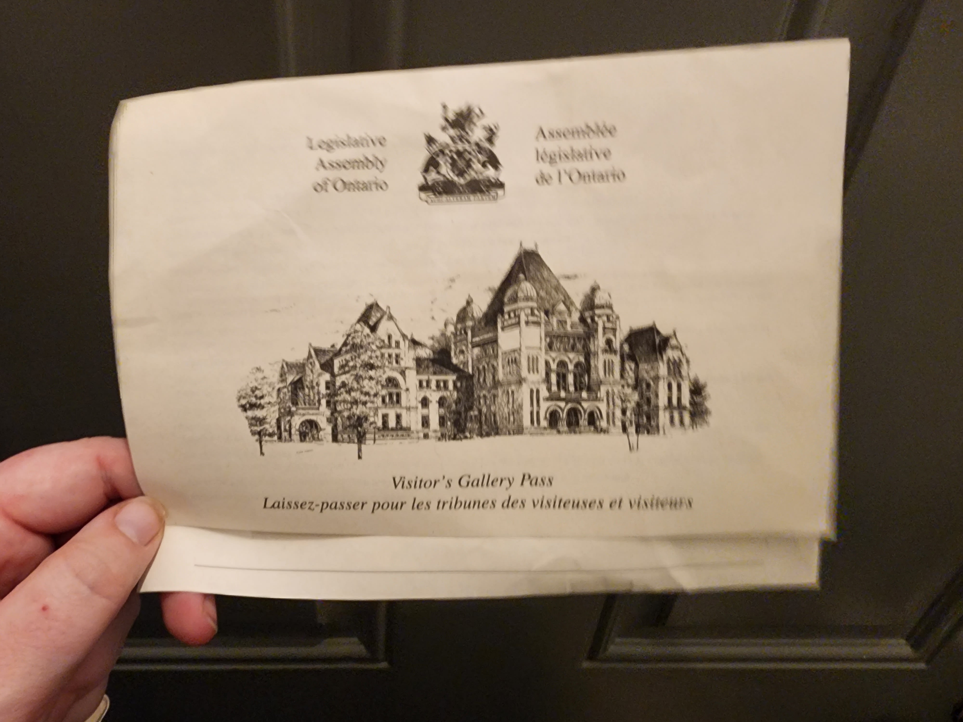 Hand holding image of Ontario Legislature Building
